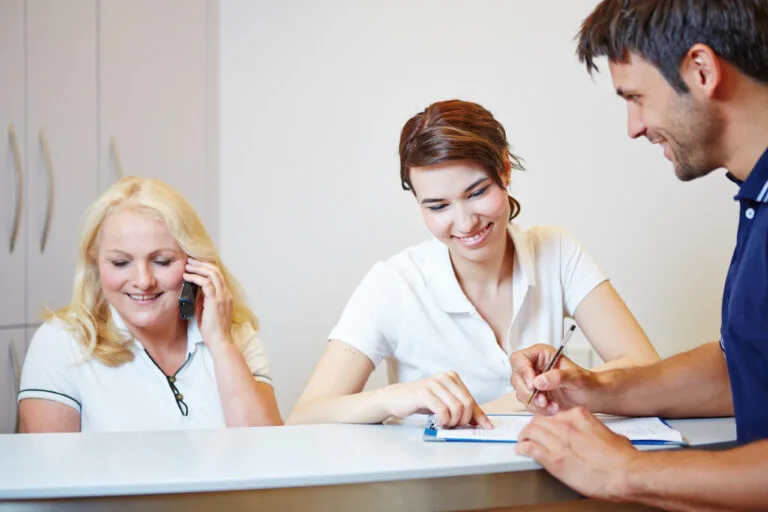 Friendly dental staff welcoming patients